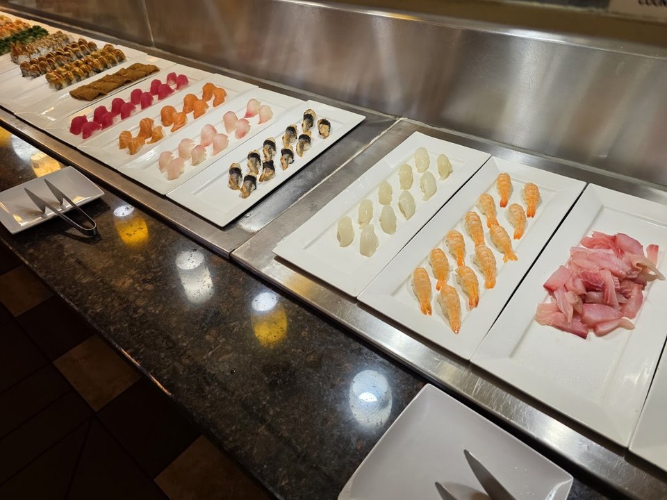 Buffet trays with seafood and Chinese dishes.